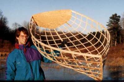 Grandson, Ryan, holds the frame of a Westport Dinghy 8 that he built with Platt